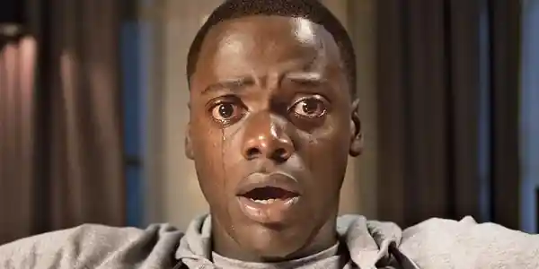 Chris frozen in the Sunken Place, tears hovering in his eyes